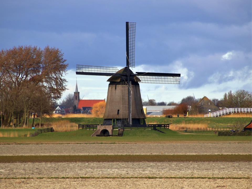 Poldermolen O met een kerk op de achtergrond